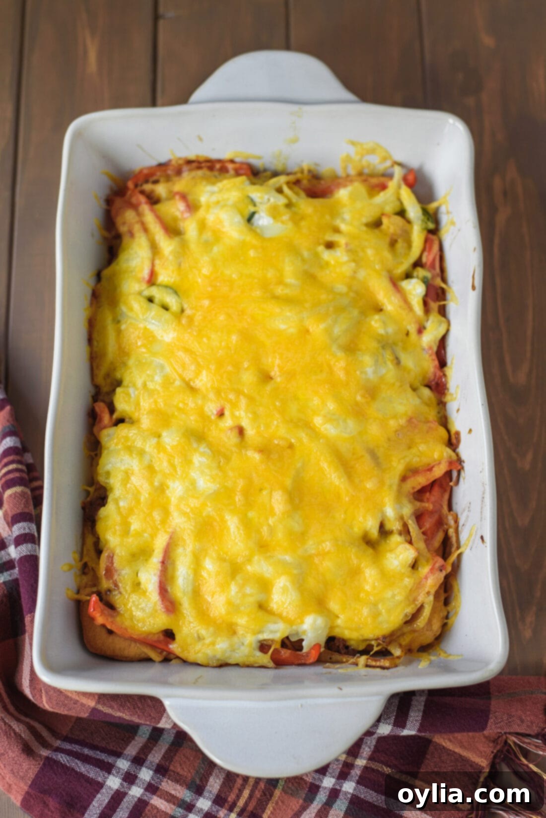 The finished John Wayne Casserole, baked to golden perfection with melted cheese, fresh out of the oven in a baking pan.