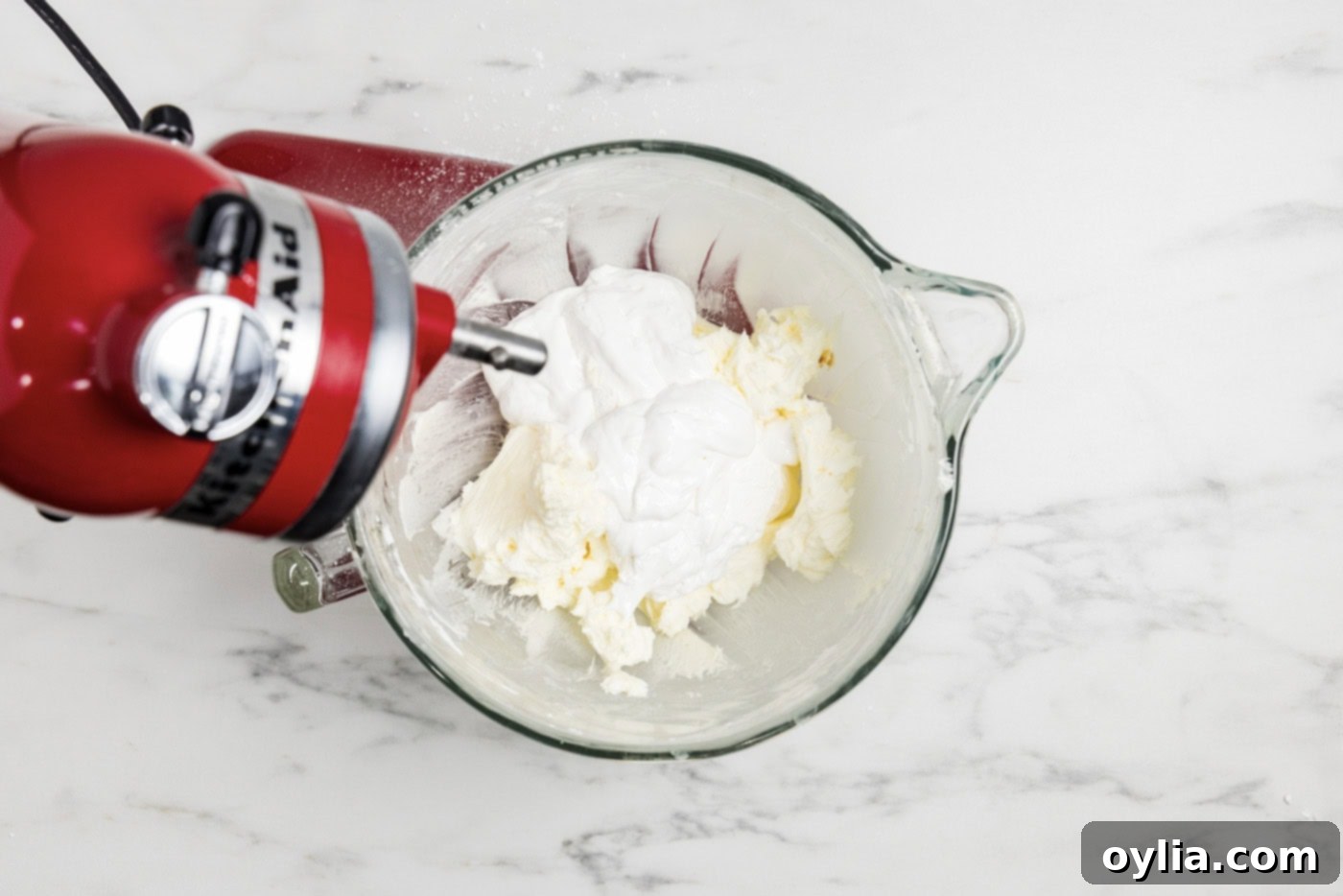 marshmallow fluff added to butter and sugar mixture in a bowl