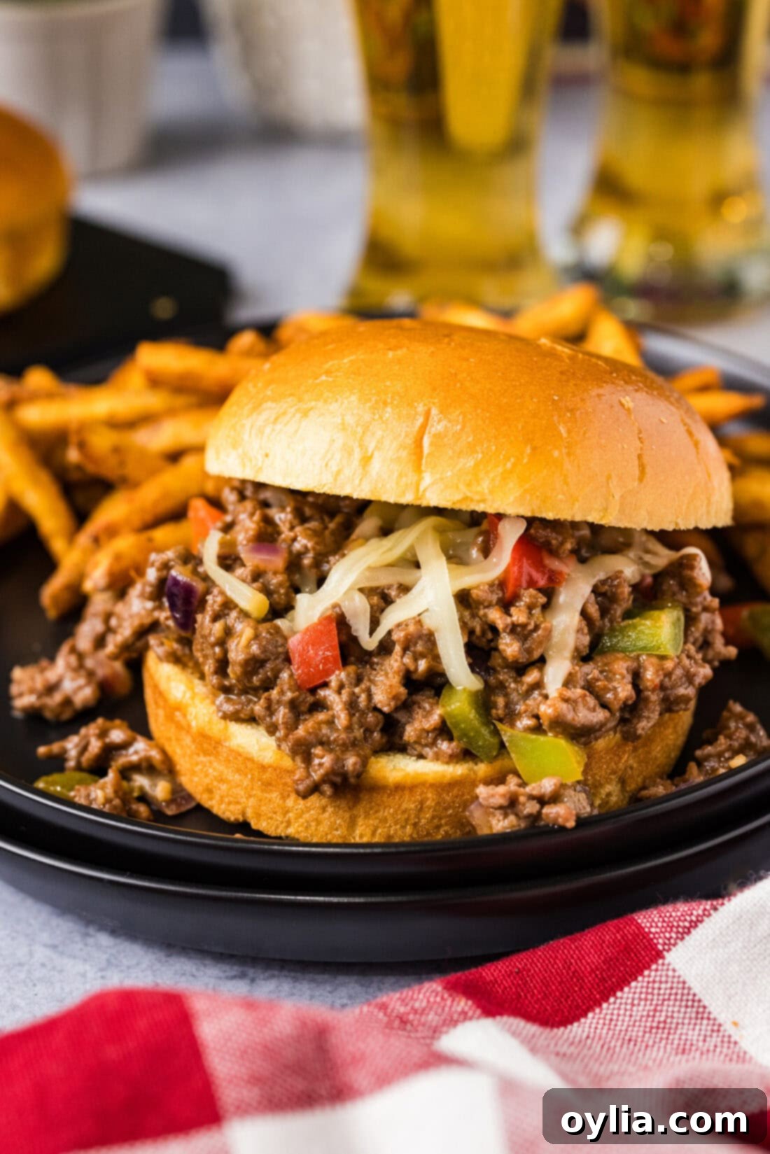 Philly Cheesesteak Sloppy Joe on a plate with french fries