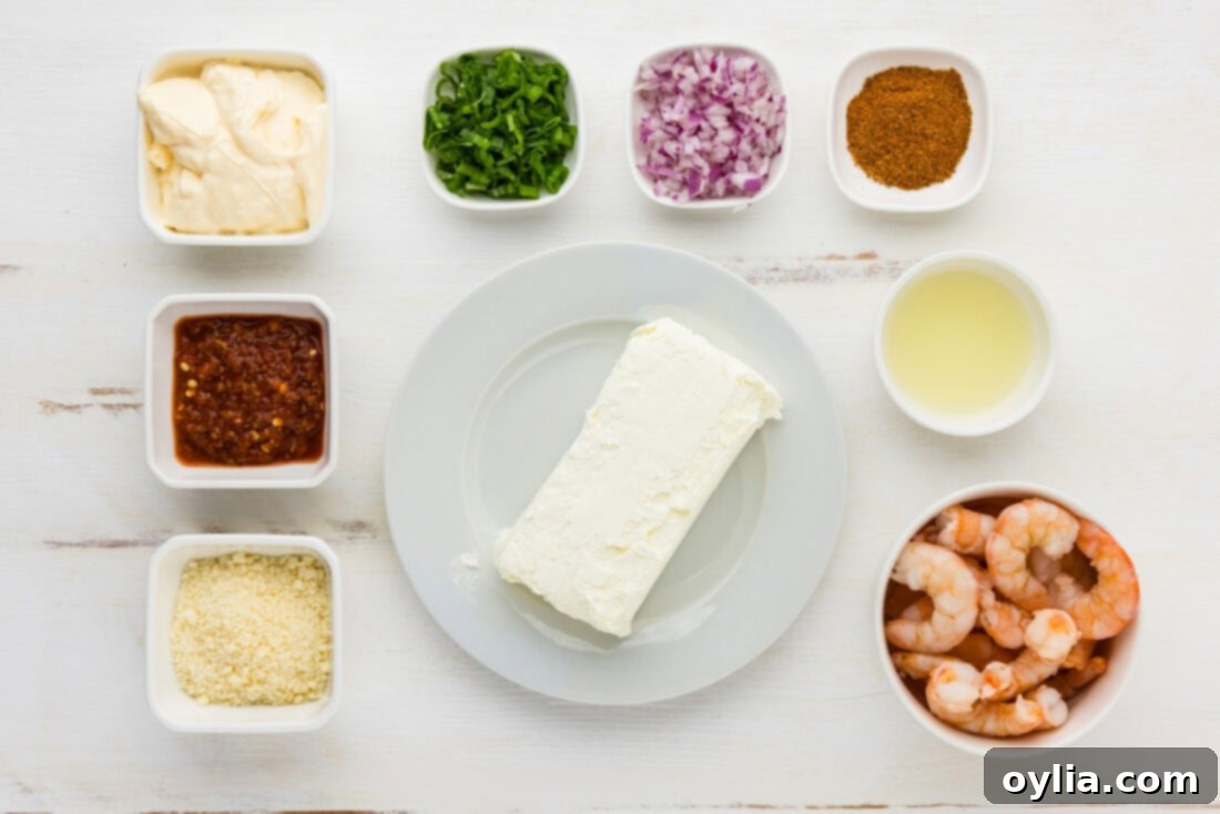 All ingredients for homemade shrimp dip laid out on a wooden board