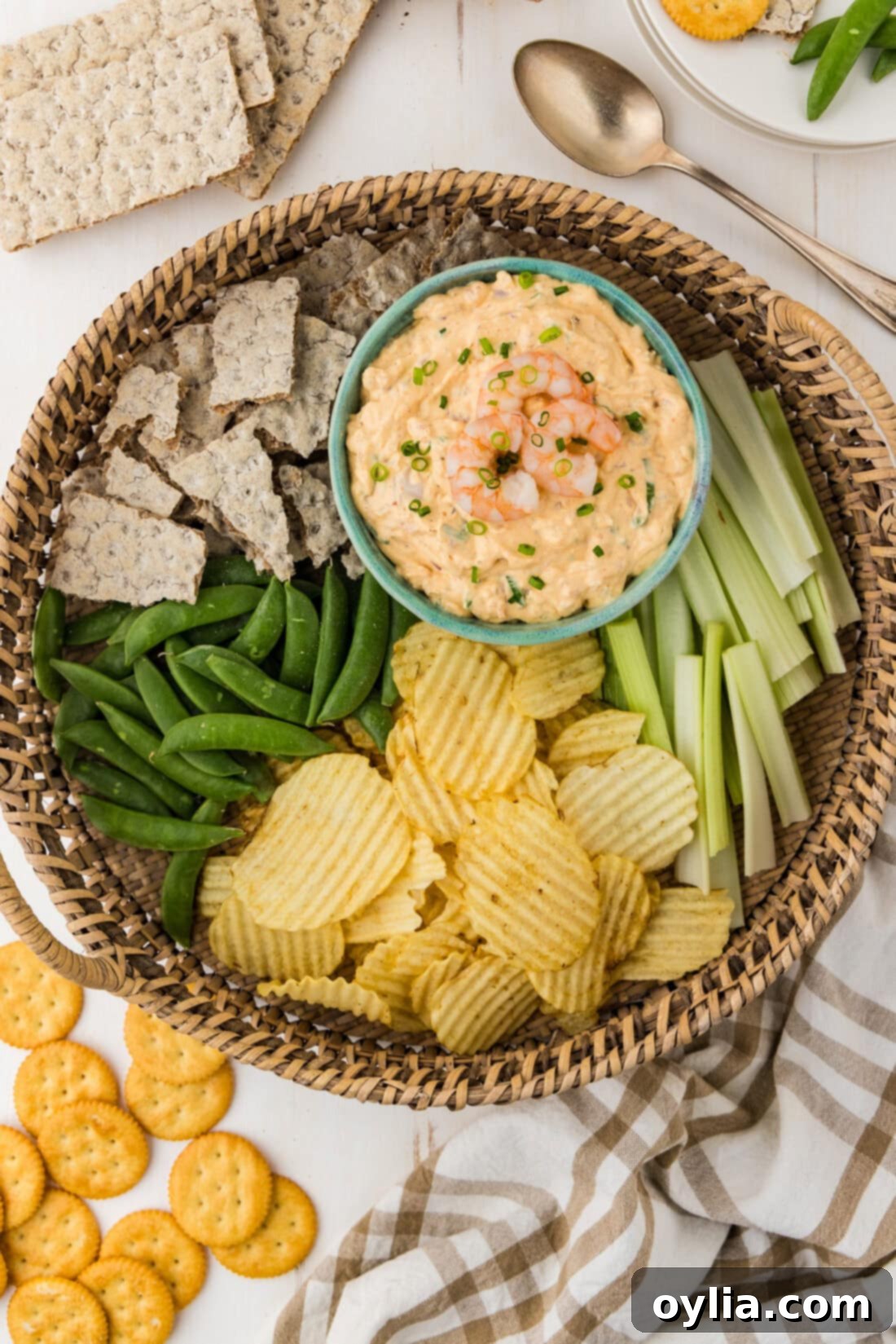 Bowl of Creamy Shrimp Dip artfully arranged on a platter with a colorful assortment of chips and fresh vegetables