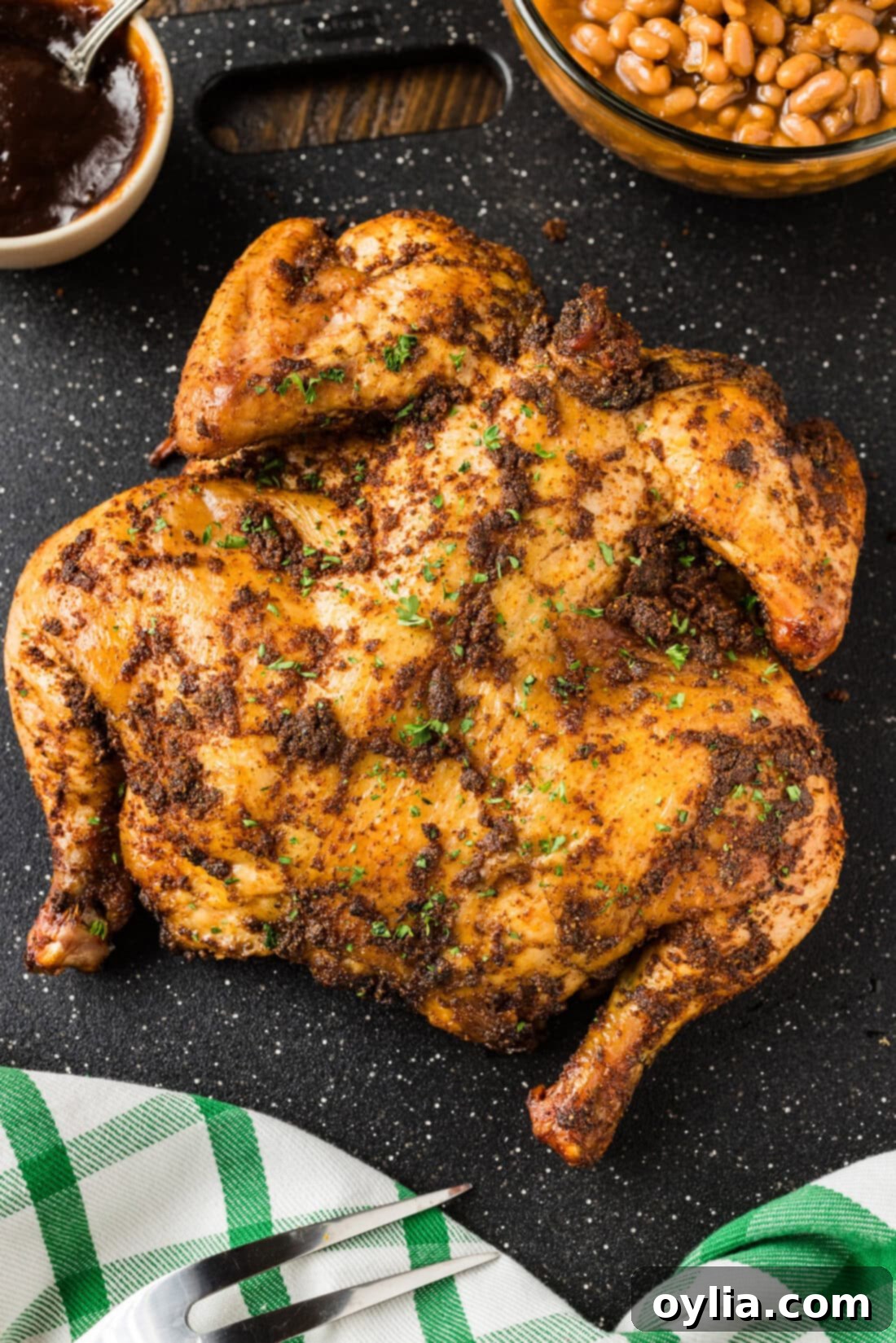 Close up photo of a Smoked Spatchcock Chicken, beautifully browned and ready to be carved.