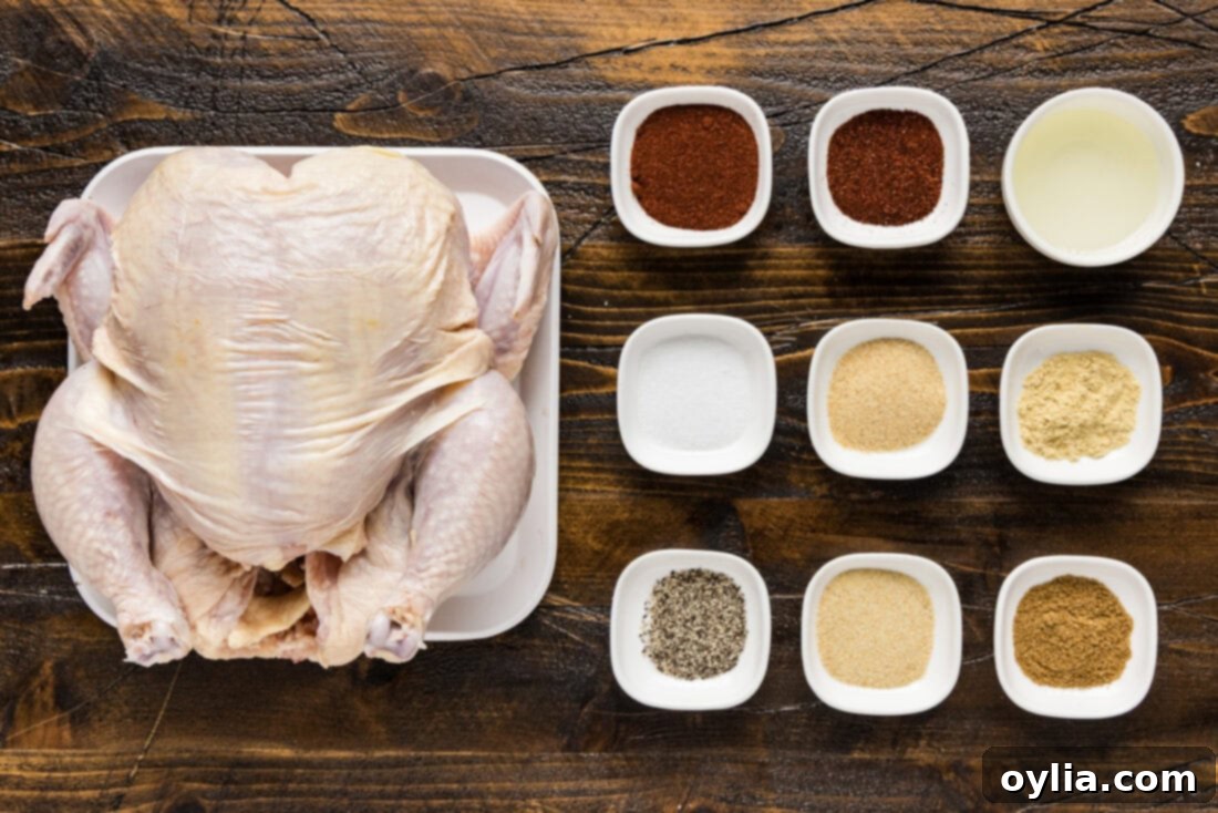 A flat lay photo showing the ingredients for Smoked Spatchcock Chicken: a whole chicken, various spices, and olive oil.