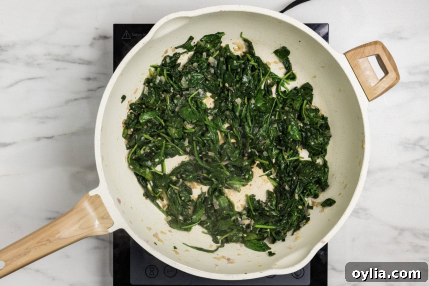 sauteed spinach mixture in a skillet
