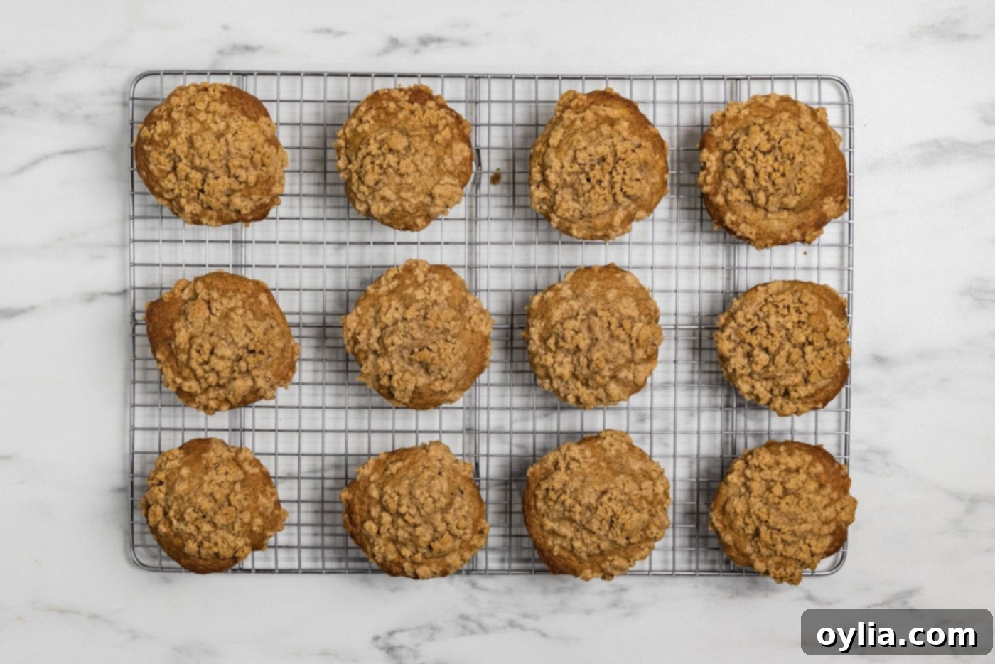baked apple streusel muffins on a wire cooling rack
