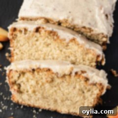 Close up photo of two slices of Apple Cider Pound Cake resting on the loaf