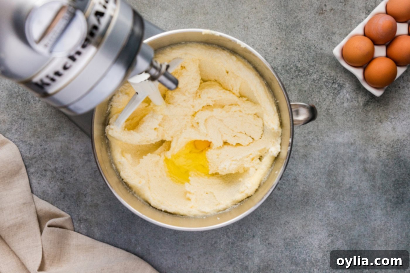Adding egg to butter and shortening mixture in a stand mixer bowl