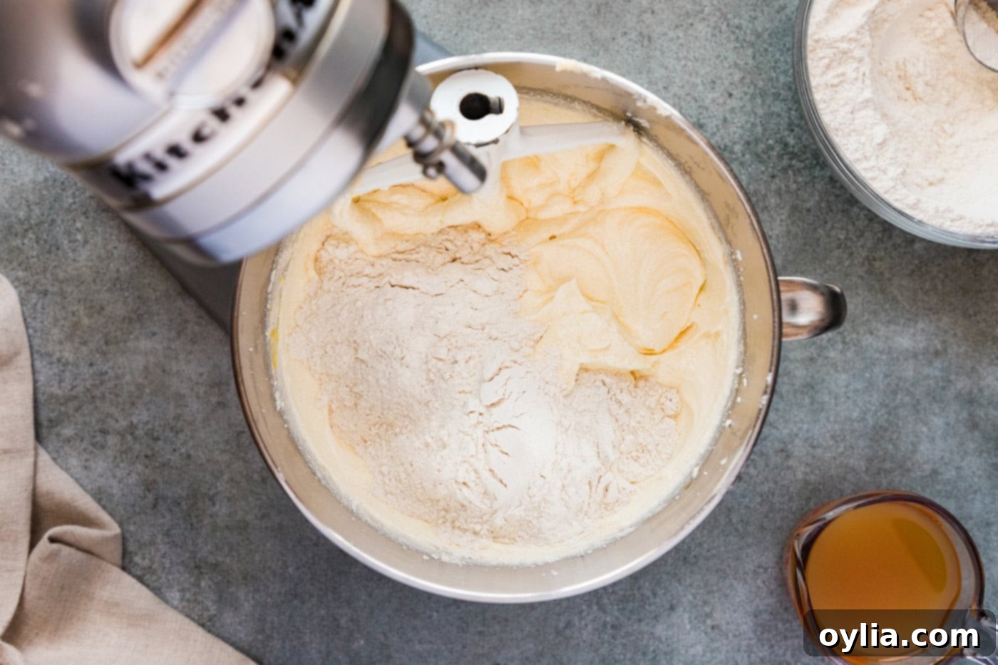 Adding dry ingredients to wet ingredients in a stand mixer bowl