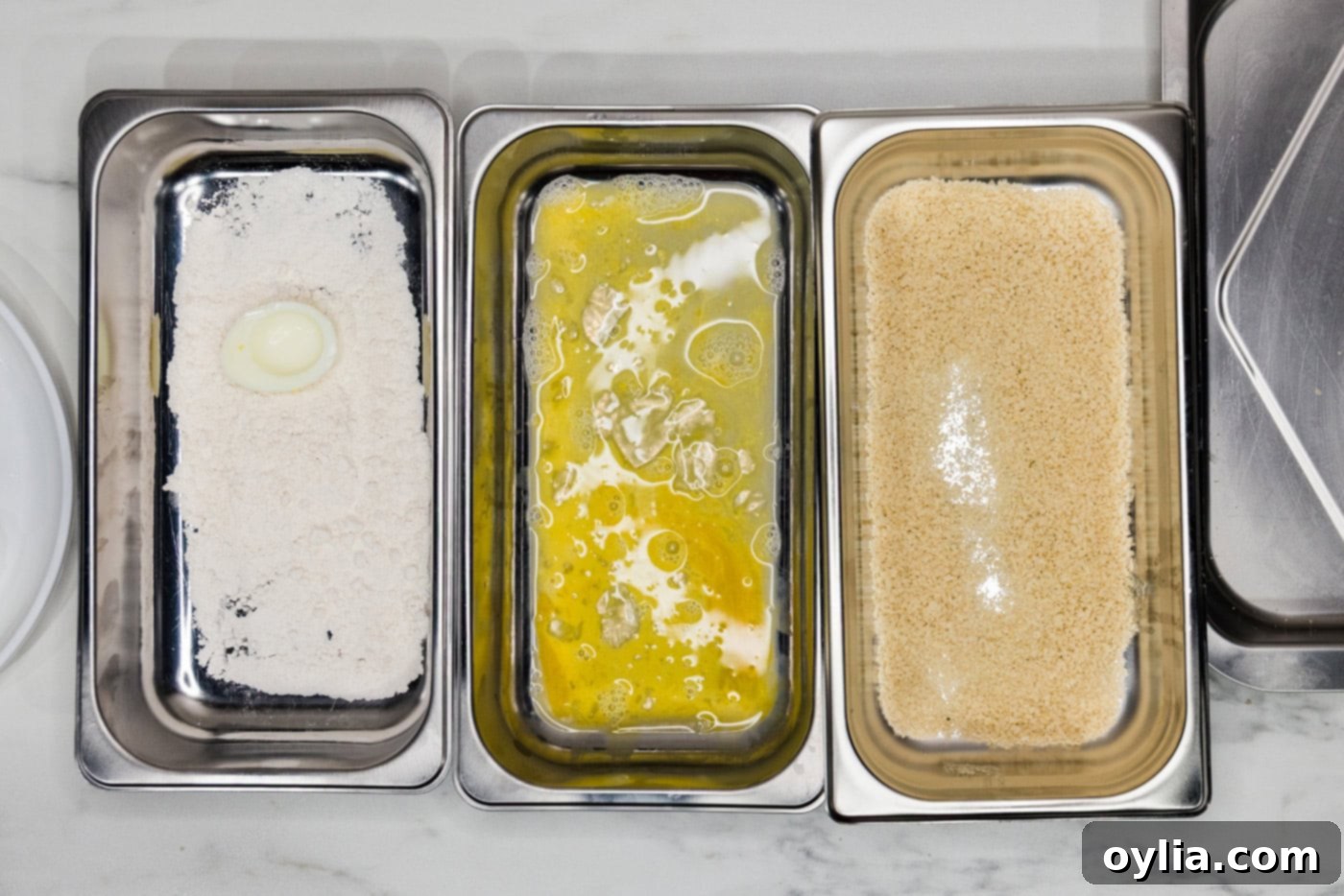 boiled egg in flour inside a breading tray