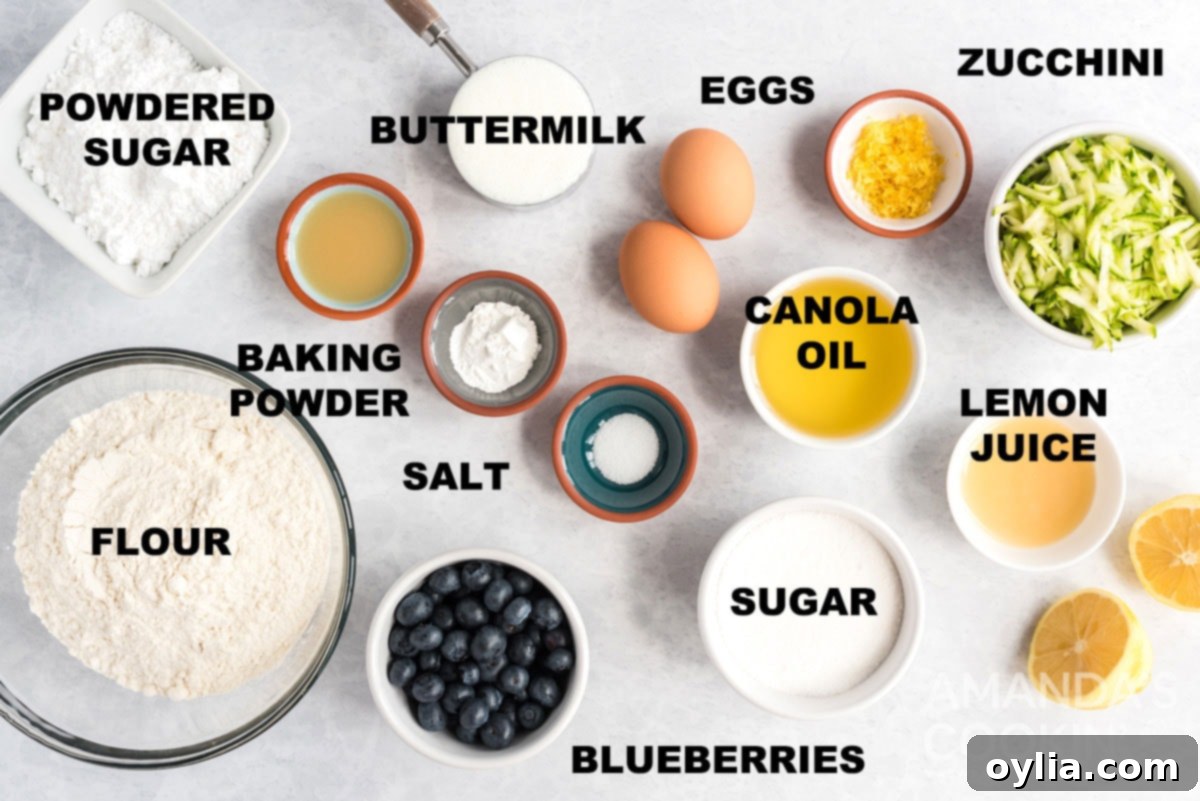 Labeled ingredients including flour, sugar, eggs, oil, buttermilk, lemon, zucchini, and blueberries arranged for Lemon Blueberry Zucchini Bread.
