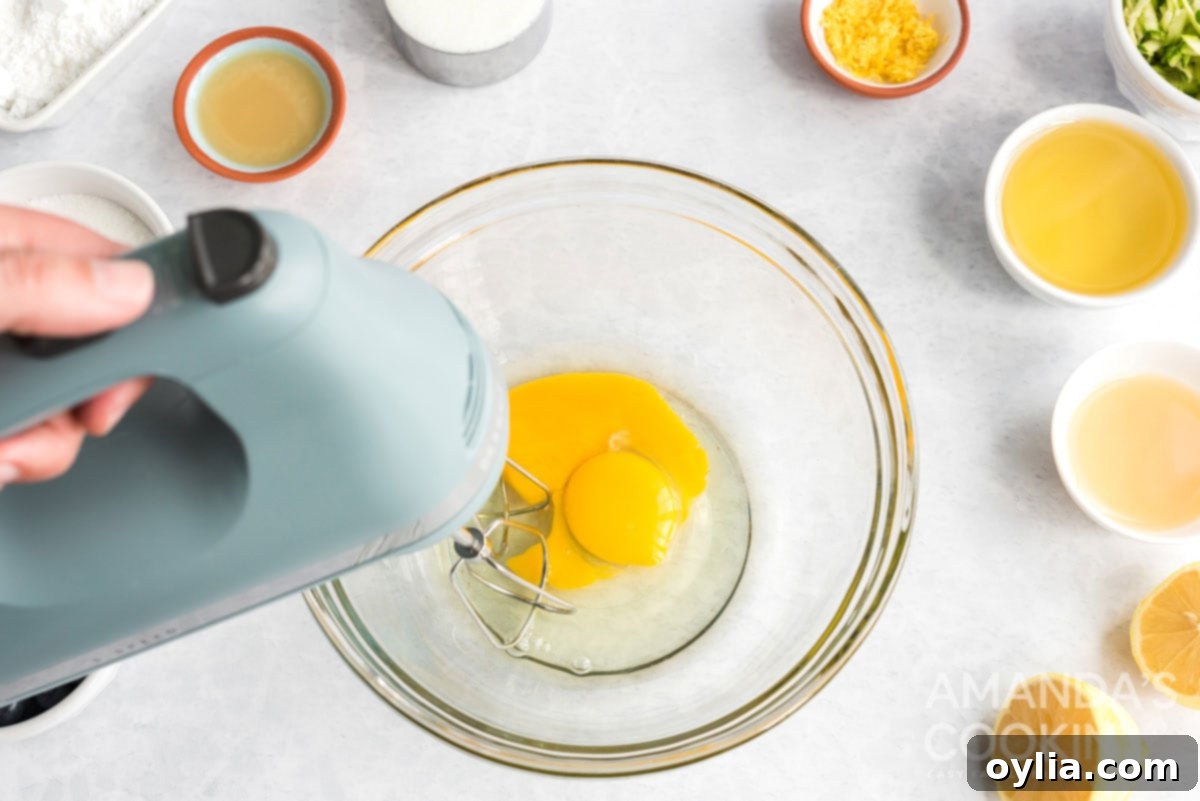 Eggs being beaten in a bowl with an electric mixer