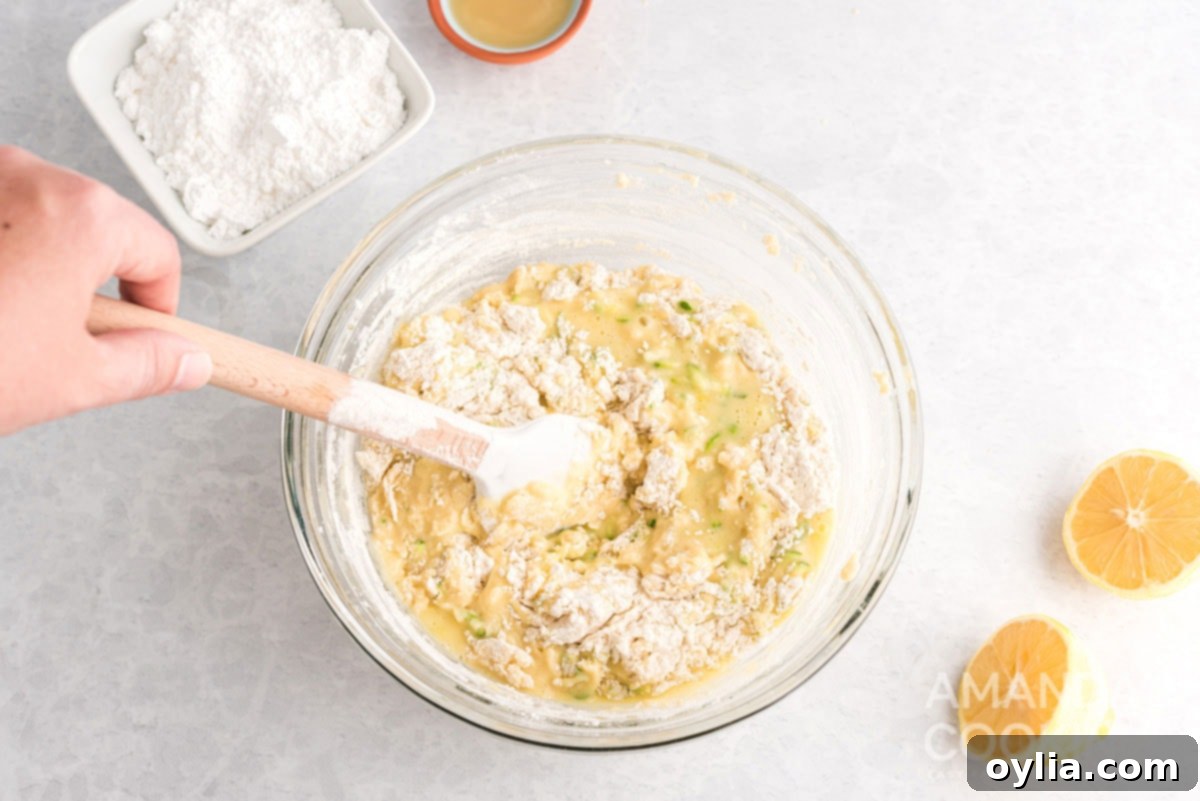 Dry ingredients being stirred into the lemon blueberry zucchini bread batter
