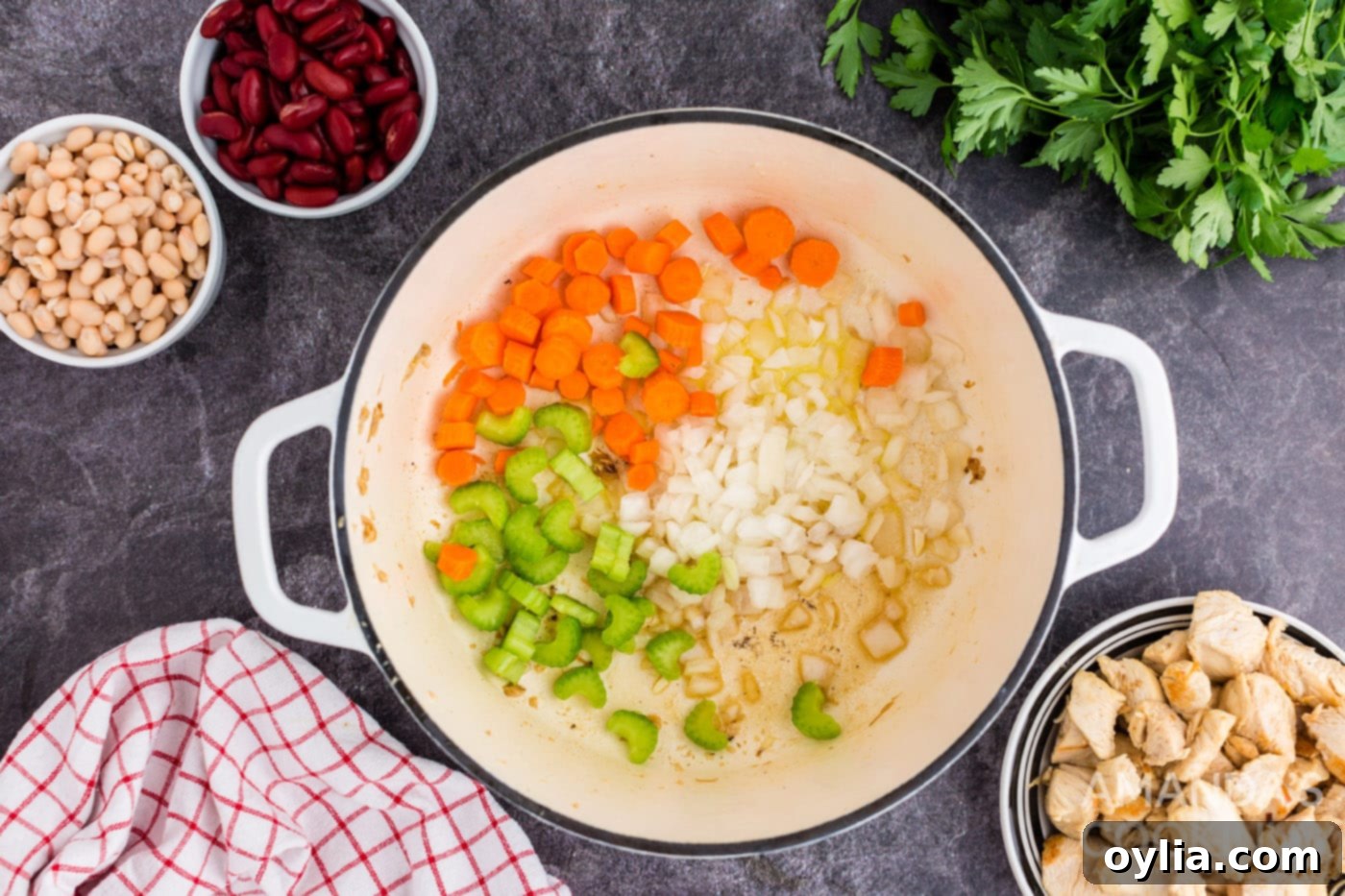 Browning chopped onion, carrots, and celery in a Dutch oven for soup base