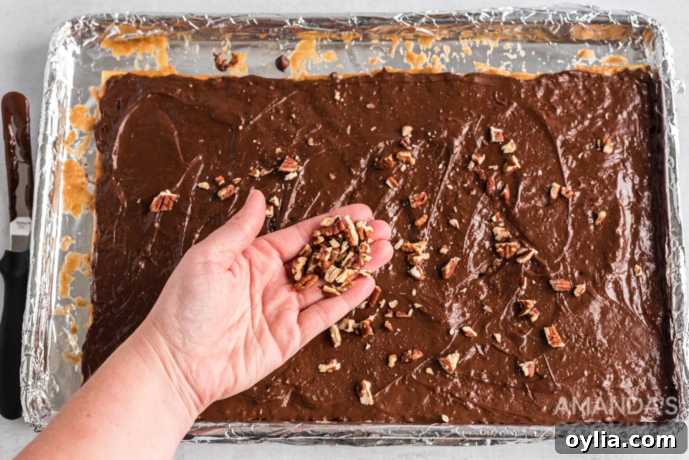 chopped nuts sprinkled on top of saltine toffee