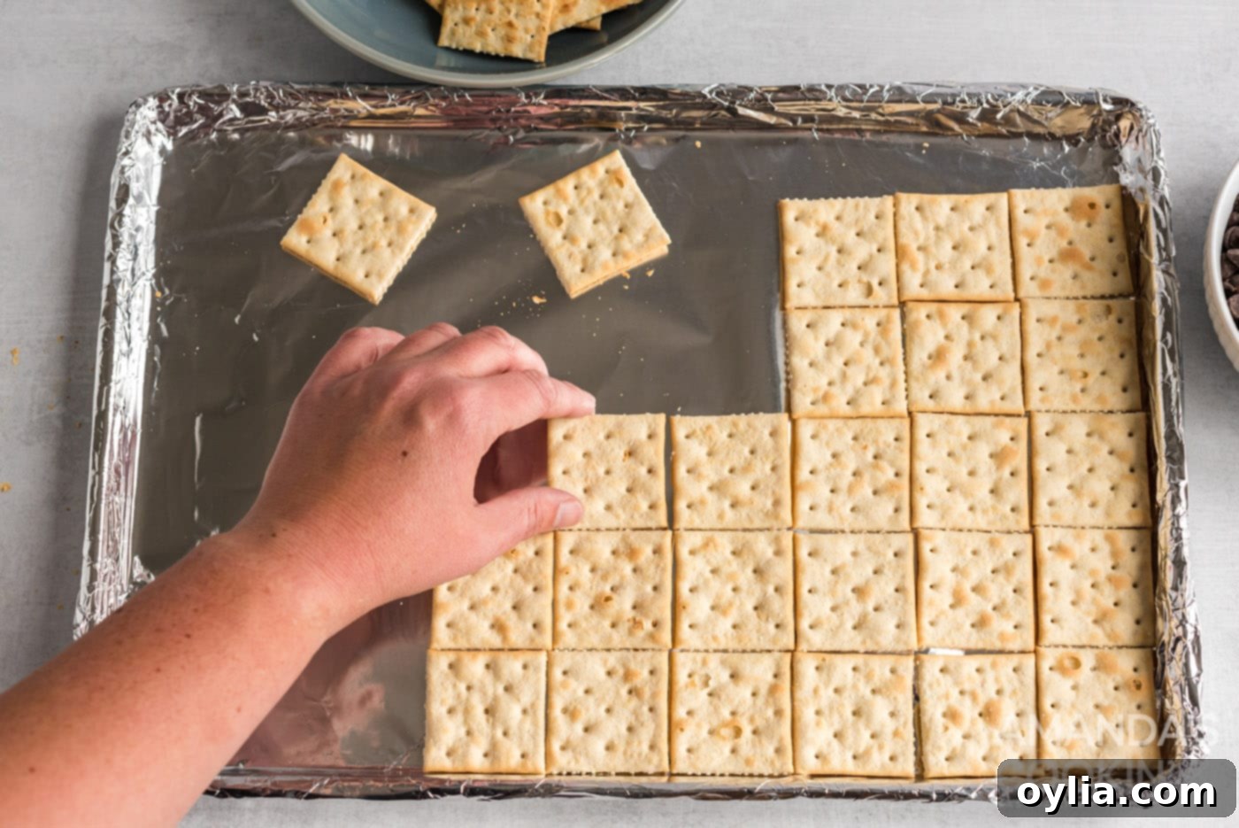 saltine crackers on a baking sheet