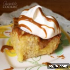Vanilla Dream Slow Cooker Cake 2 A close up photo of vanilla dream crock pot cake topped with Cool Whip and drizzled Dulce de Leche.