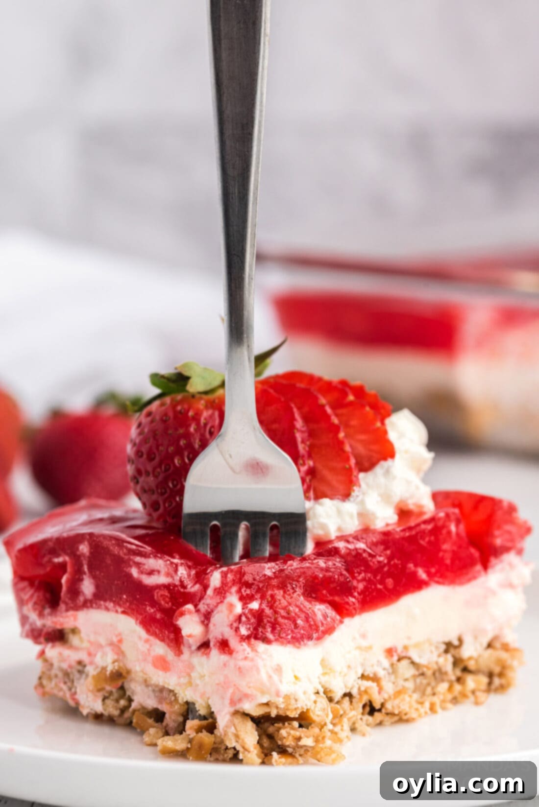 fork in a slice of Strawberry Pretzel Salad