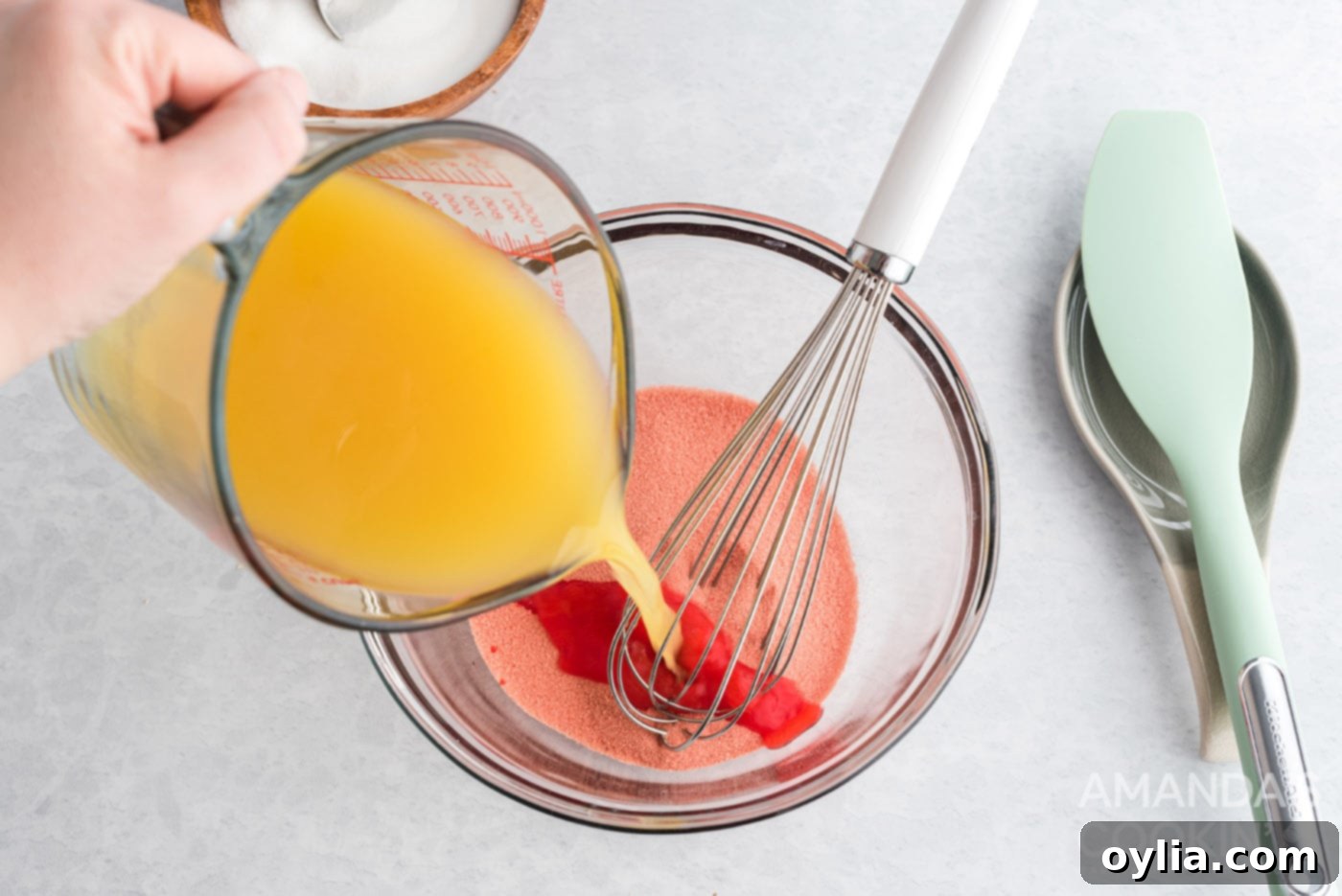 pouring pineapple juice into strawberry gelatin