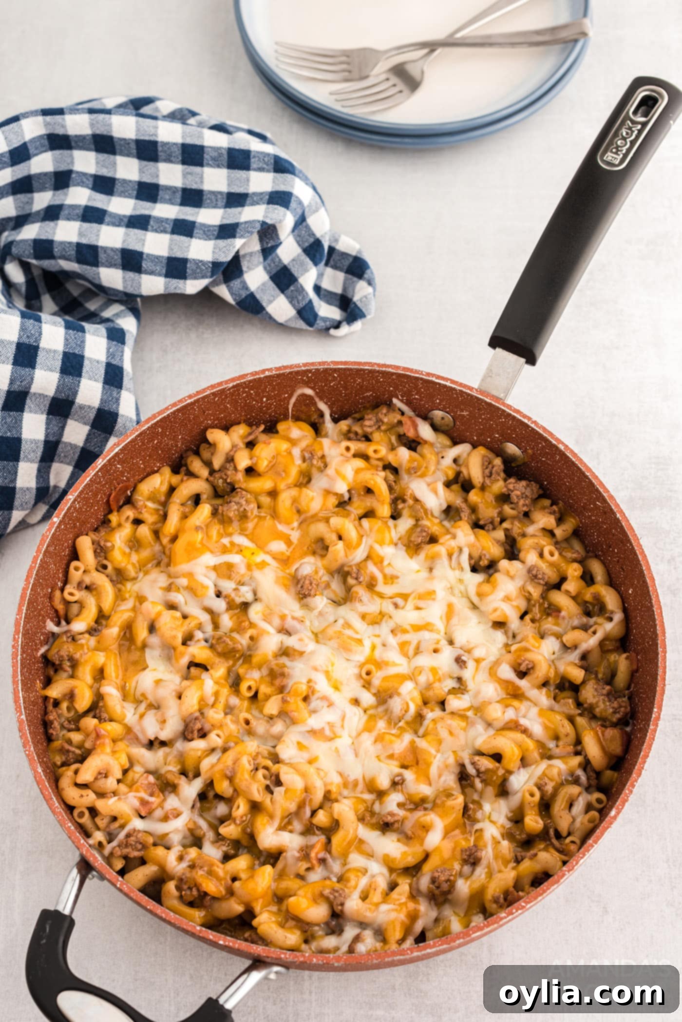 The finished Bacon Cheeseburger Casserole in a skillet, with perfectly melted cheese topping