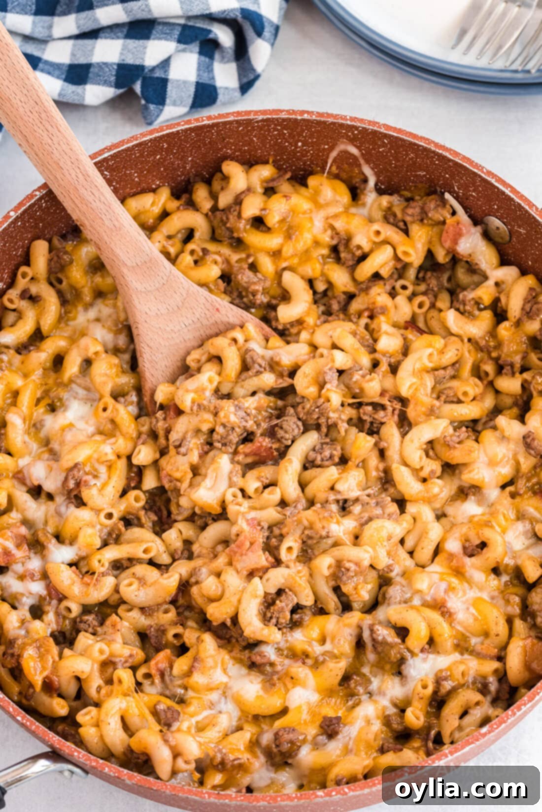 A large skillet filled with bubbling Bacon Cheeseburger Casserole, topped with melted cheese, ready to be served