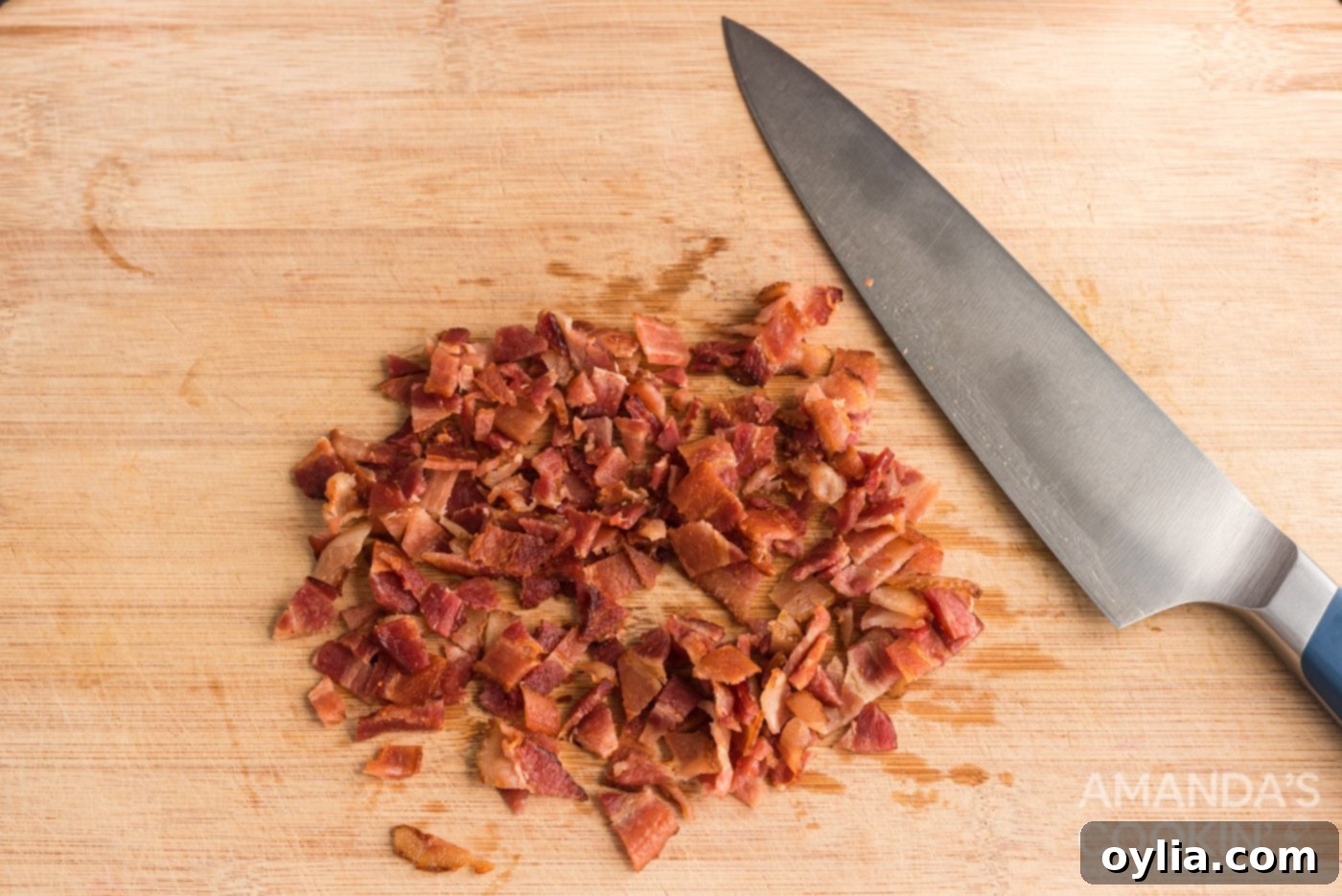 Chopped crispy bacon pieces on a cutting board, ready to be added to the casserole