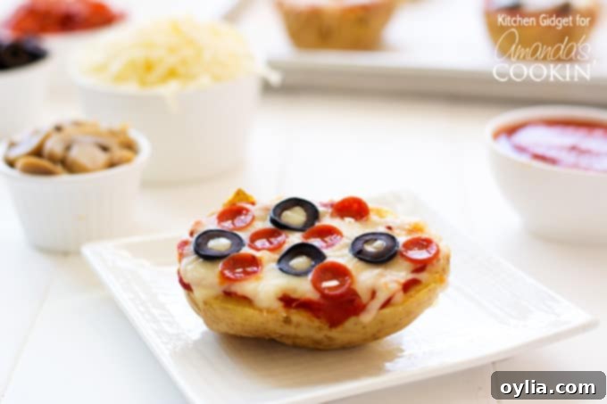 A close up of a baked potato pizza on a white plate topped with pepperoni and black olives.