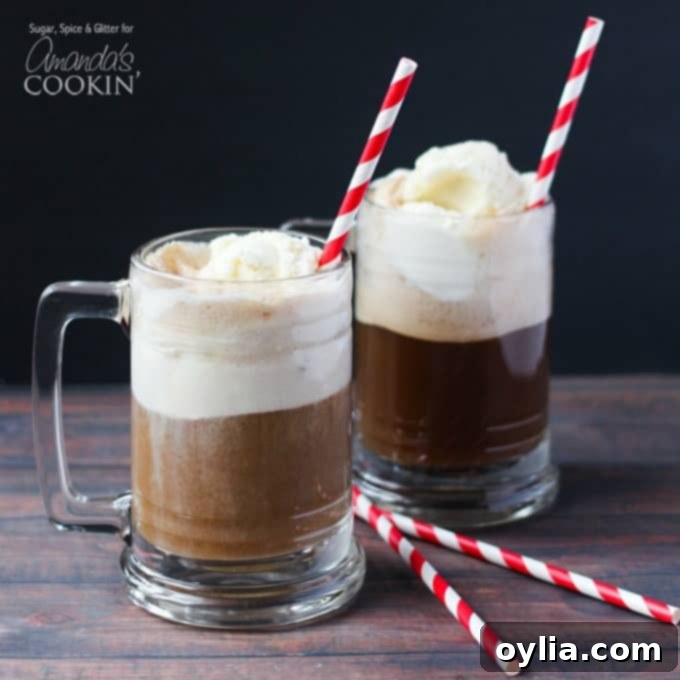 A close up photo of two root beer float cocktails in clear mugs served with red and white stripped straws.