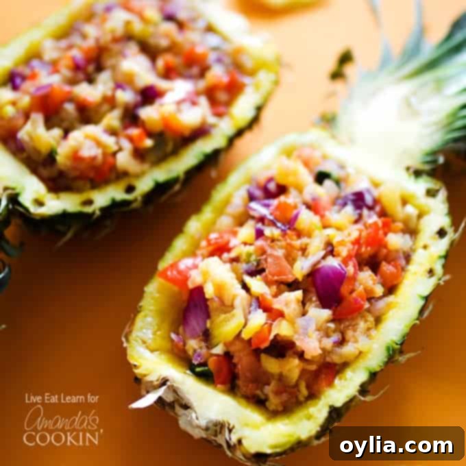 A photo of vibrant pineapple salsa, beautifully served in halved pineapple shells, garnished with fresh mint leaves.