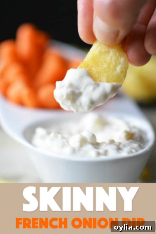 A close up photo of a potato chip dipped in skinny French onion dip.