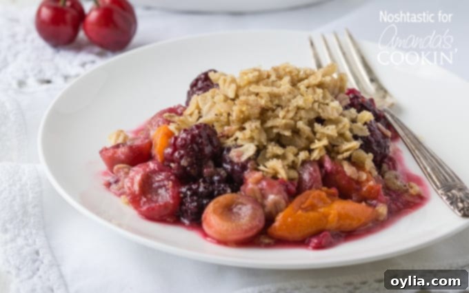A close up of summer fruit crisp on a white plate.