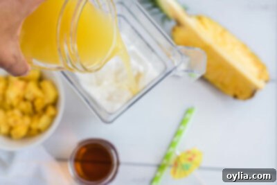 adding pineapple juice to blender
