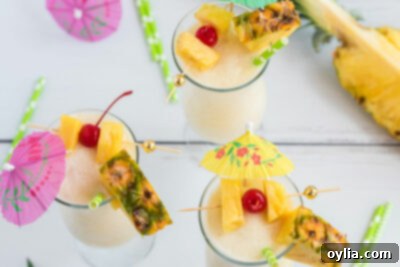 3 pina coladas with cherry and pineapple garnishes