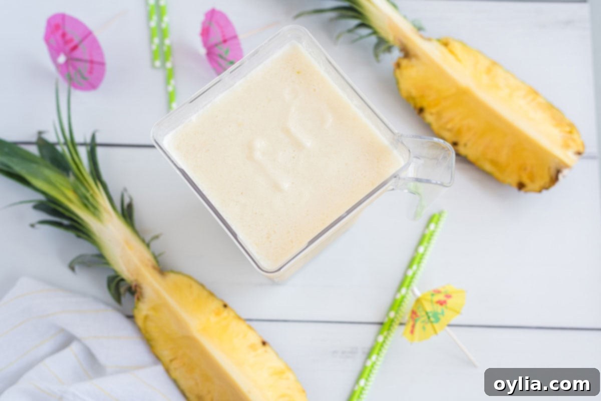 Blender full of creamy Pina Colada mixture, ready to be poured.