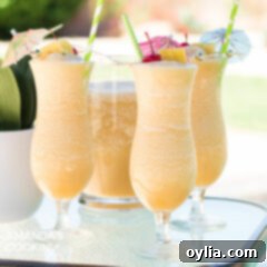 Three Pina Colada cocktails on a table by the pool, inviting a relaxing summer mood.