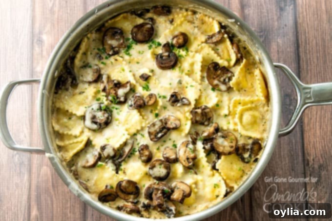 This creamy mushroom ravioli dish starts on the stove and finishes in the oven making it the perfect weeknight dinner. A stovetop casserole! creamy mushroom ravioli in a cast-iron pan, ready to be served, garnished with fresh parsley