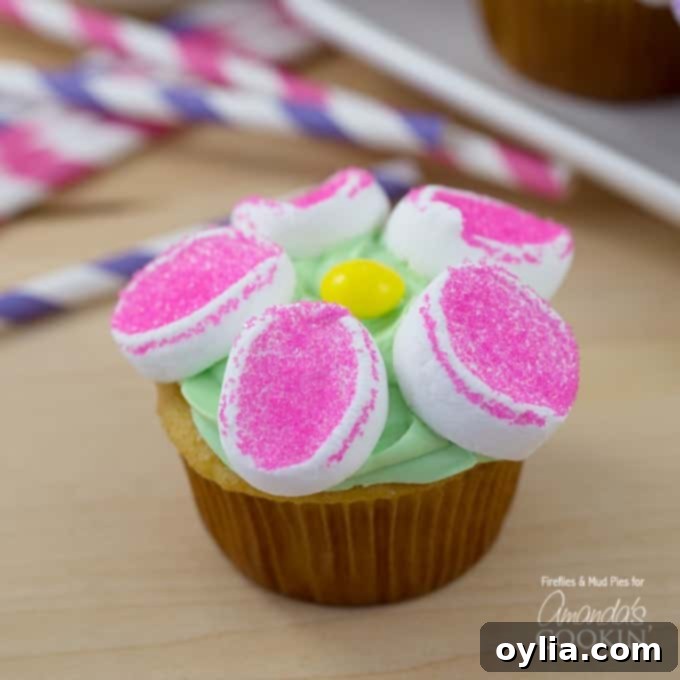 A close up of a marshmallow flower cupcake.