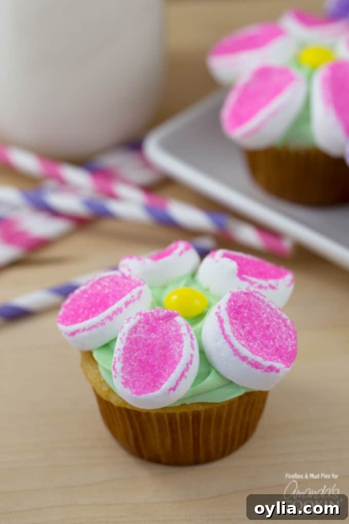 A close up of a marshmallow flower cupcake.