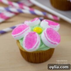 A close up of a marshmallow flower cupcake.