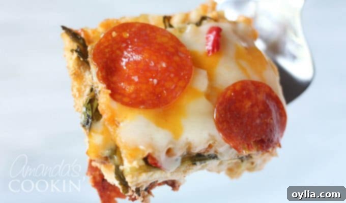 A close up photo of a slice of pizza lasagna on a plate, showcasing the distinct layers and melted cheese.