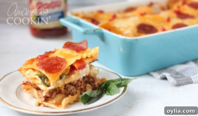 A close up photo of pizza lasagna on a white and gold plate, with the remaining full dish in the background, creating an inviting scene.