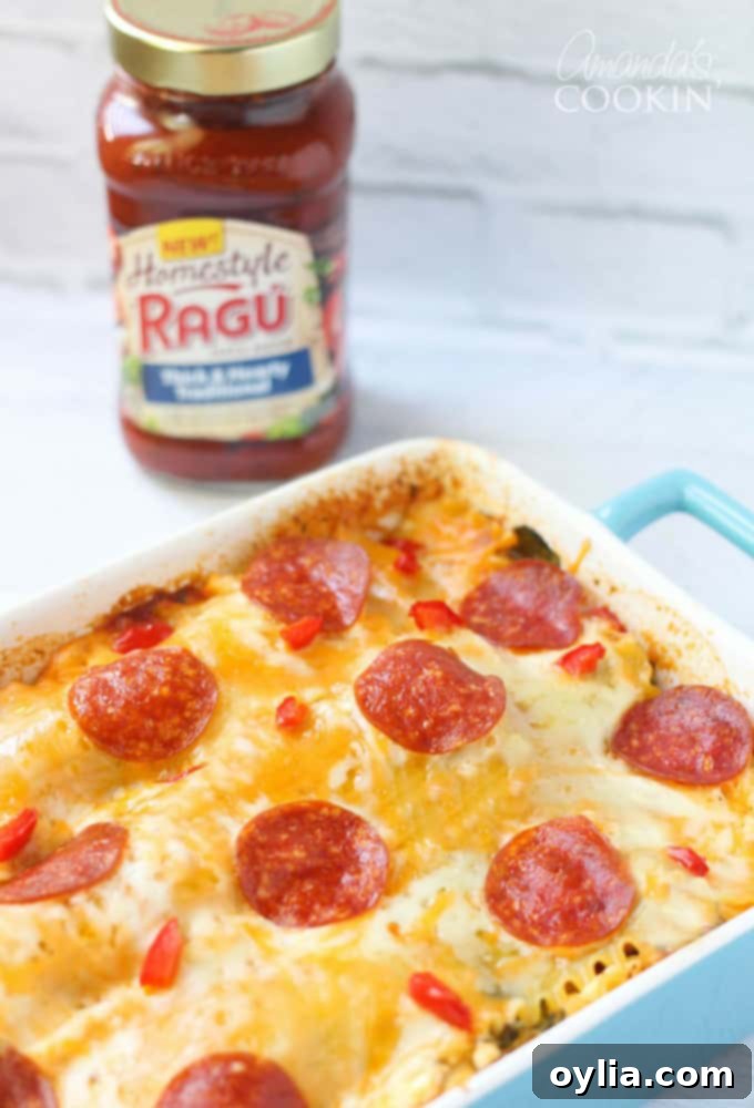 A close up photo of pizza lasagna in a vibrant blue casserole dish, showing the delicious layers of cheese and sauce.