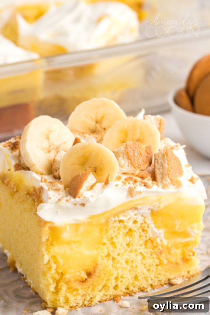 close up photo banana pudding poke cake slice