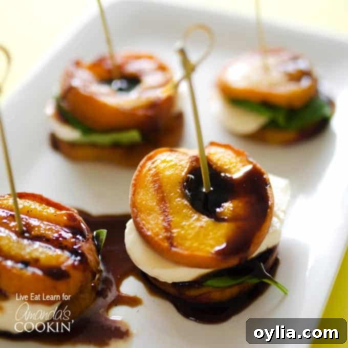 A close up of grilled peach caprese on a white platter. 