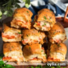 Stacked Pizza Sliders showcasing melted cheese and golden buns