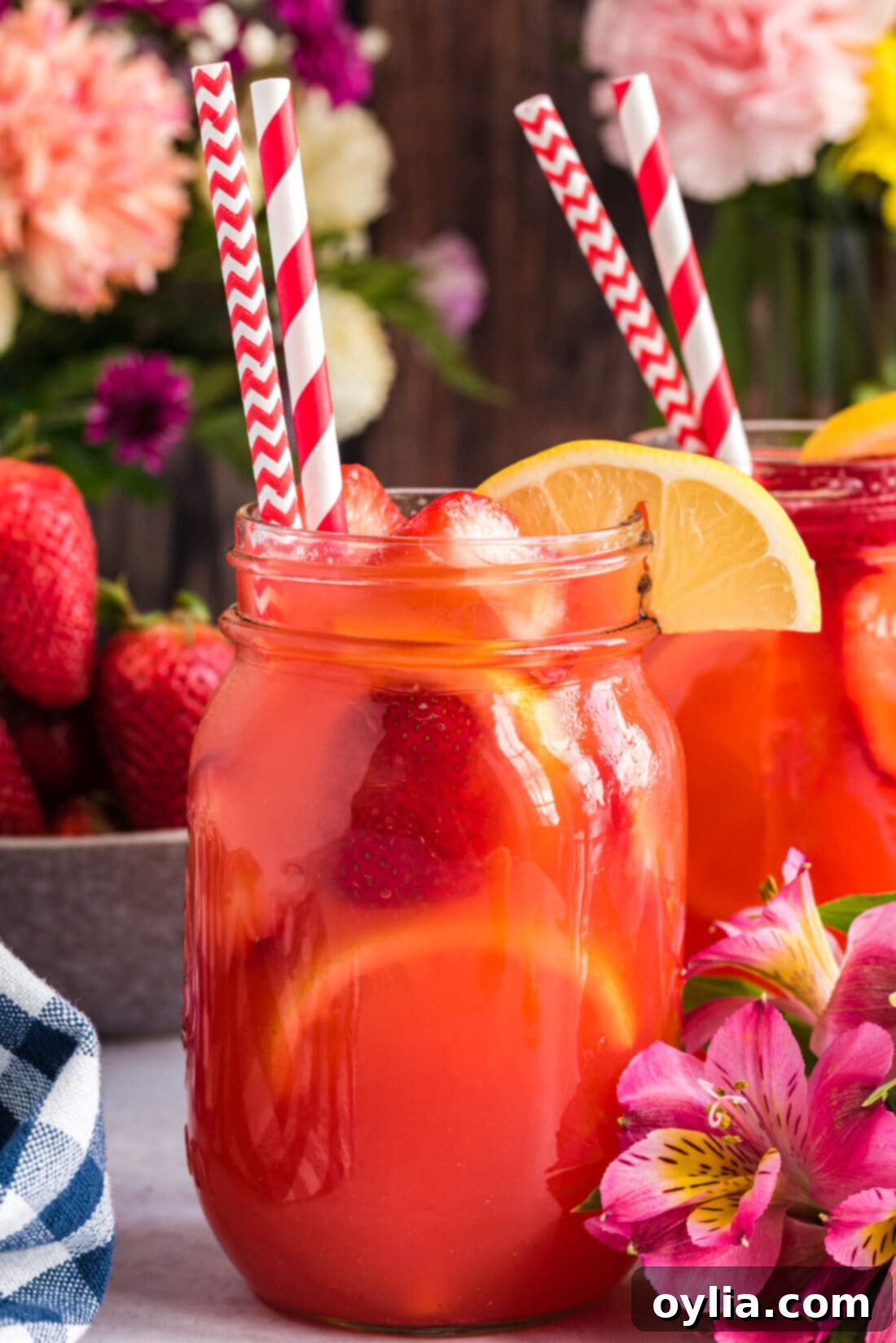 Easy Strawberry Lemonade in a mason jar, garnished with fresh fruit