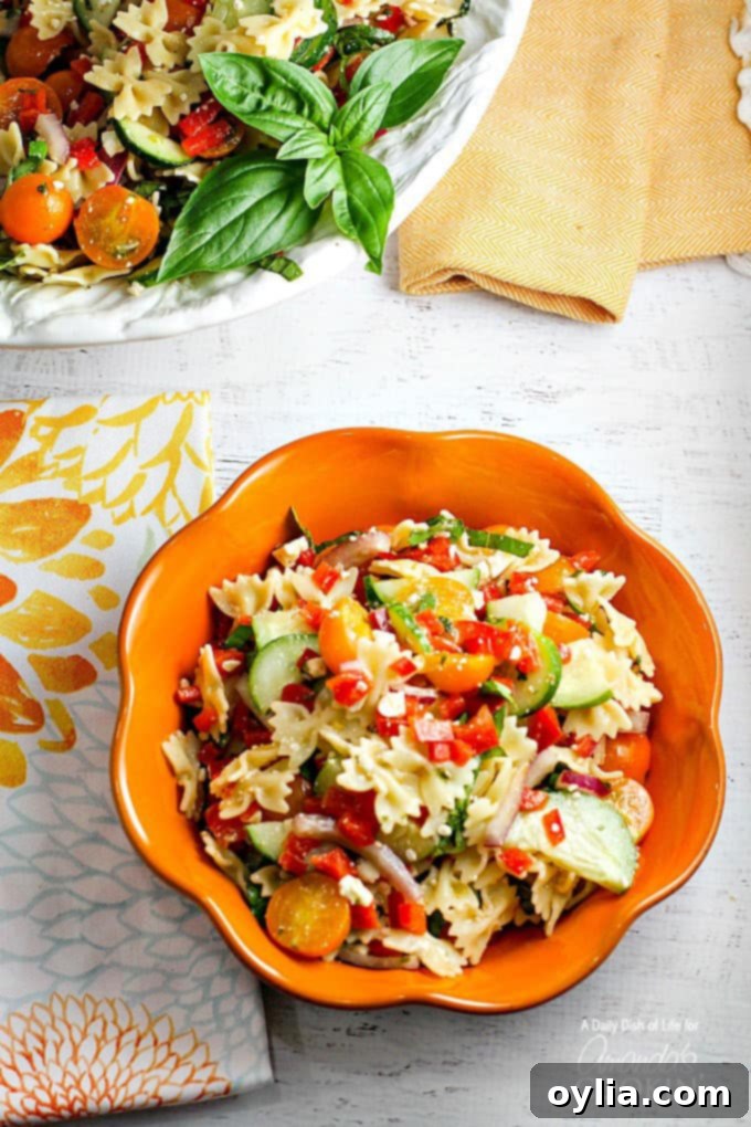 summer pasta salad in orange bowl
