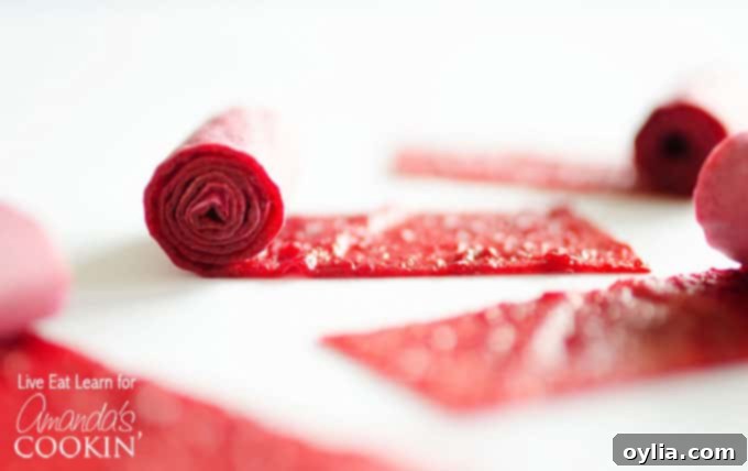A close up of homemade fruit roll ups being rolled.