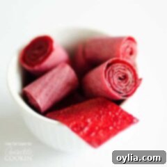 A close up of plum fruit roll ups in a white bowl.