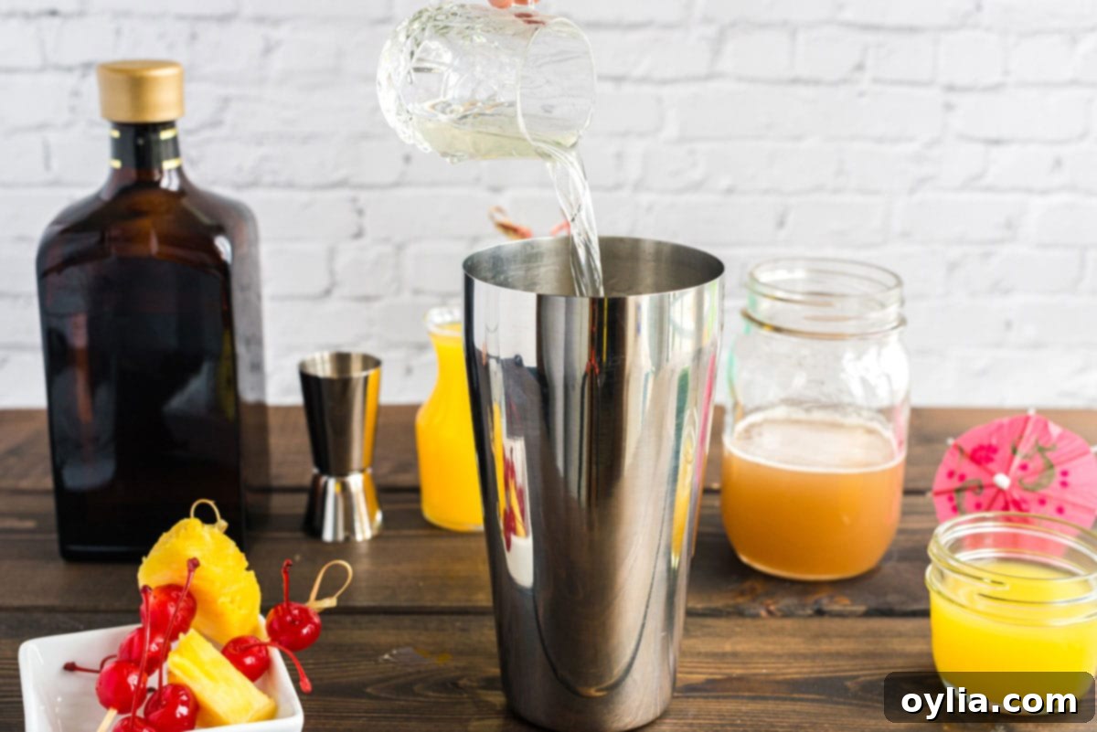 pouring rum into cocktail shaker