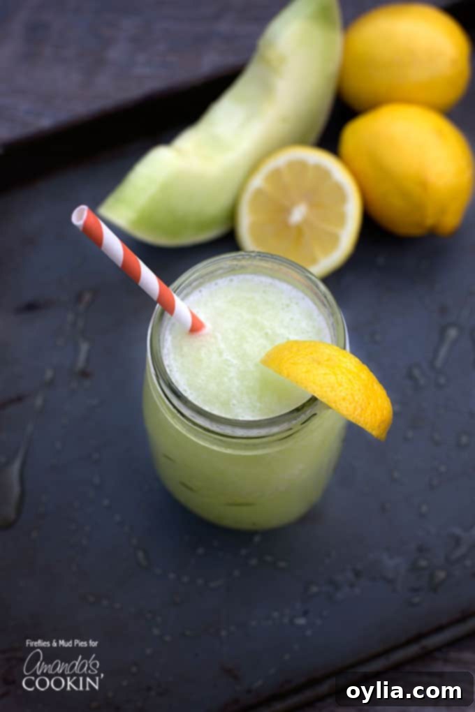 A beautiful overhead shot of a mason jar filled with vibrant green honeydew lemon slush, garnished with a fresh lemon wedge and served with a charming red and white striped straw, inviting you to take a refreshing sip.